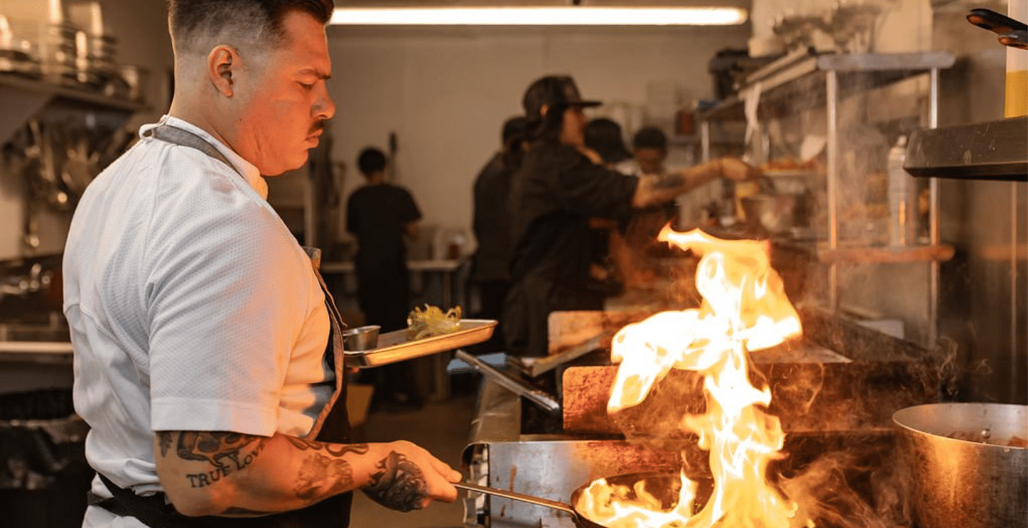 A chef cooking in a commercial kitchen