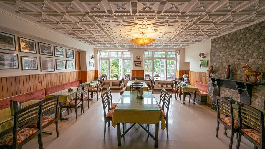 Front view of restaurant seating with stylish interiors at Himalaya Hotel, Nainital