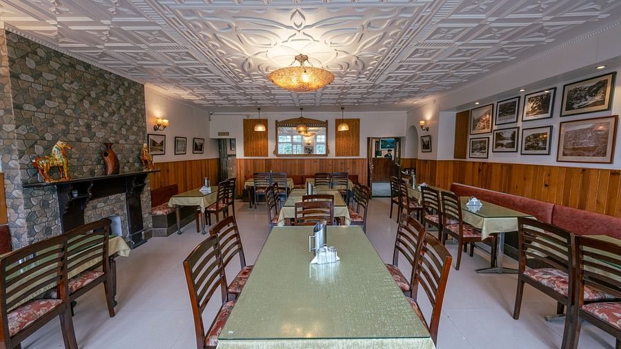 Front view of restaurant seating with stylish interiors at Himalaya Hotel, Nainital