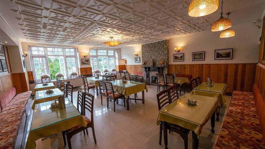 Side view of restaurant seating with stylish interiors at Himalaya Hotel, Nainital