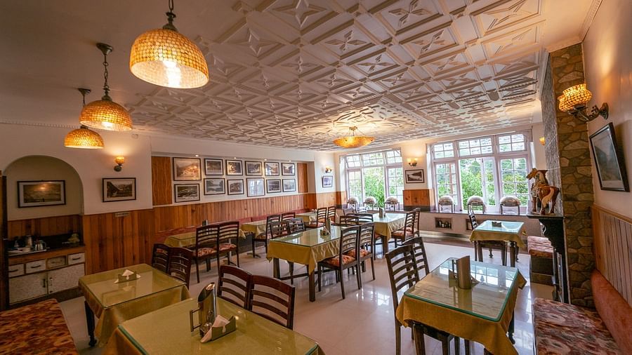 Side view of restaurant seating with stylish interiors at Himalaya Hotel, Nainital