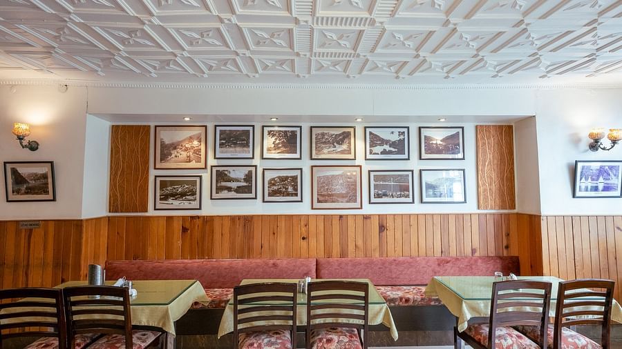 Side view of restaurant seating with stylish interiors at Himalaya Hotel, Nainital