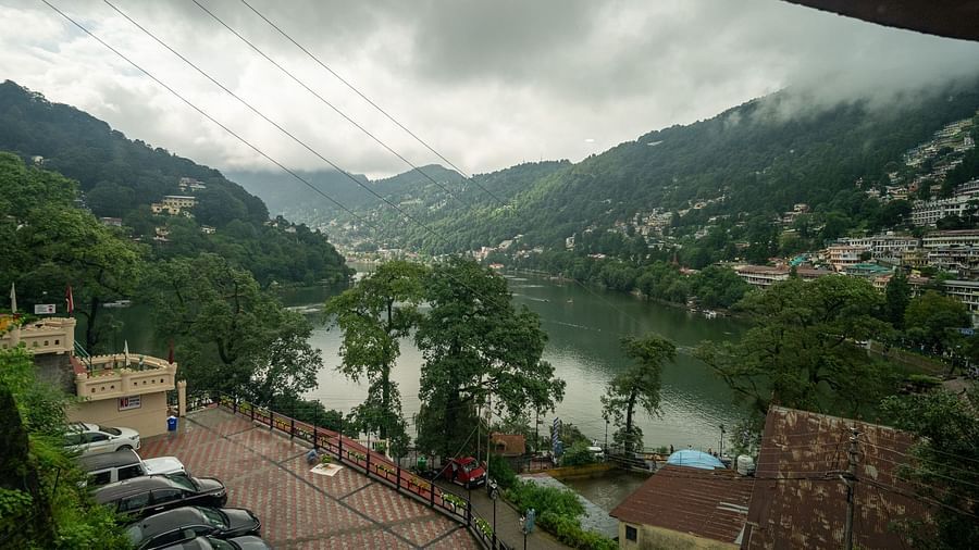 Scenic lake panorama from Himalaya Hotel, Nainital featuring Naini Lake surrounded by terraced hillside development and lush green mountain slopes.