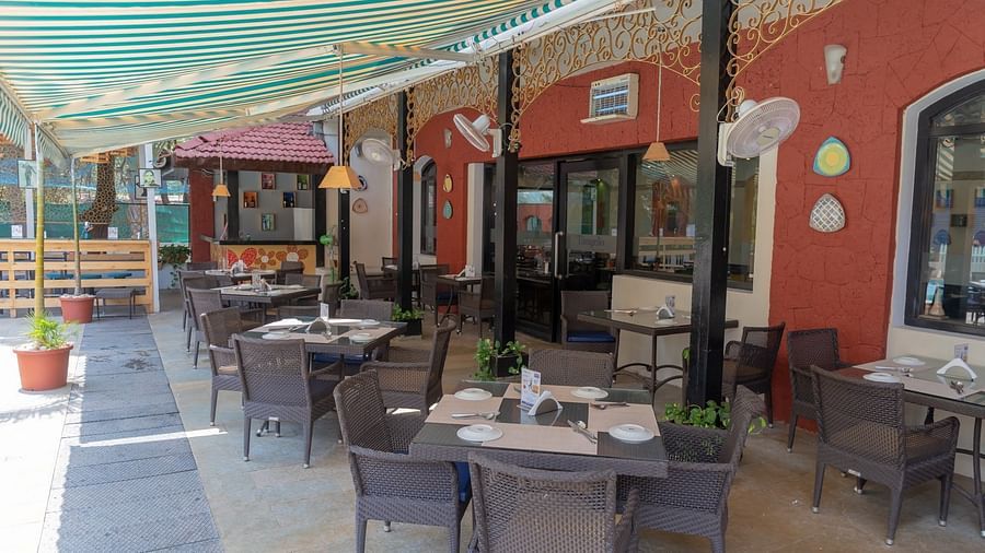 Seating by the poolside at Kyriad Prestige Calangute, Goa
