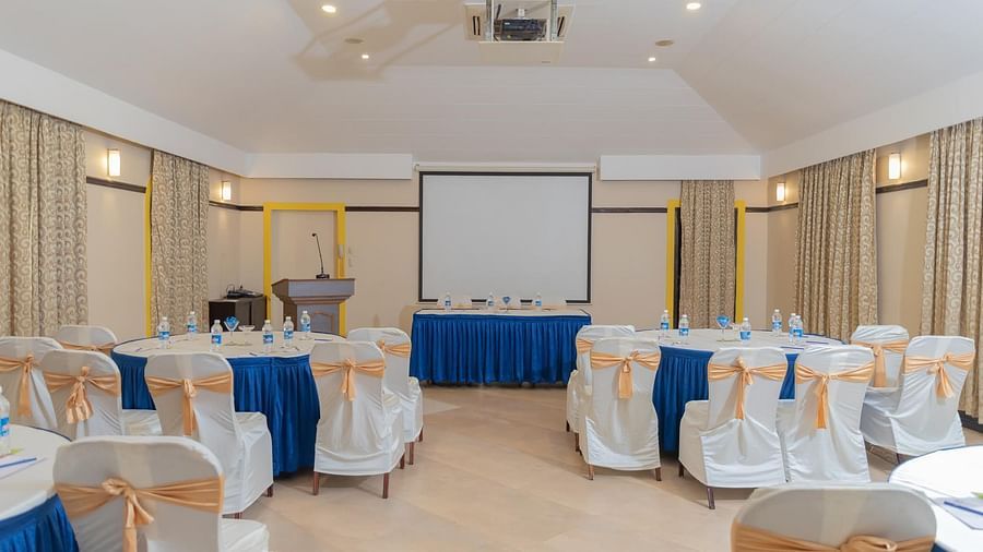 All the chairs facing at a white board at Chairs set in a U-shaped seating at Opera Banquet Hall at Kyriad Prestige Calangute, Goa