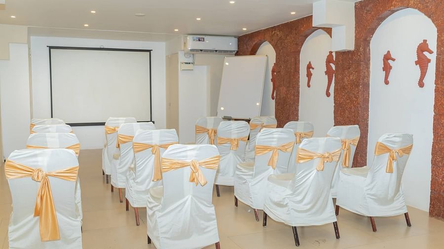 Chairs aligned in a row facing a whiteboard at Opera Banquet Hall at Kyriad Prestige Calangute, Goa