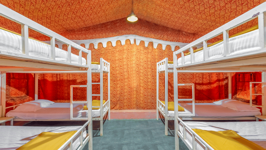 20 bed dormitory with multiple bunk beds, bright interiors, and spacious shared sleeping arrangement.