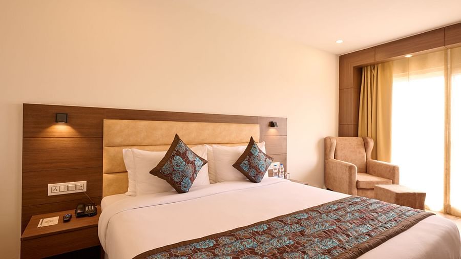 a deluxe bed with cushions and balcony