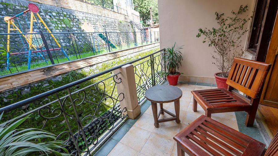 Outdoor seating with two chairs and a round table at The Pavilion, Nainital