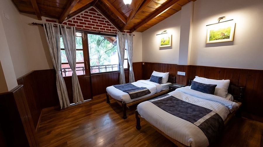 Two cosy bed with a view from the window at The Pavilion, Nainital