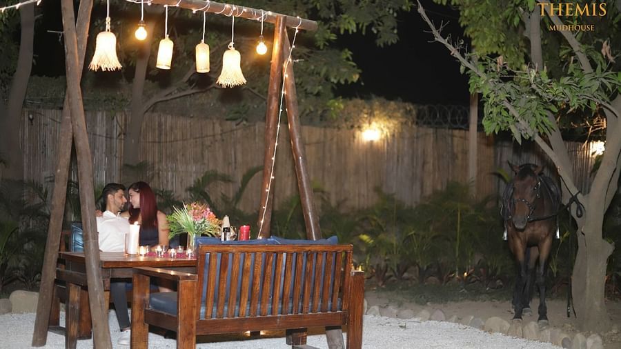 A couple on a dinner date at Themis Mudhouse - A Nature's Retreat Resort & Wellness