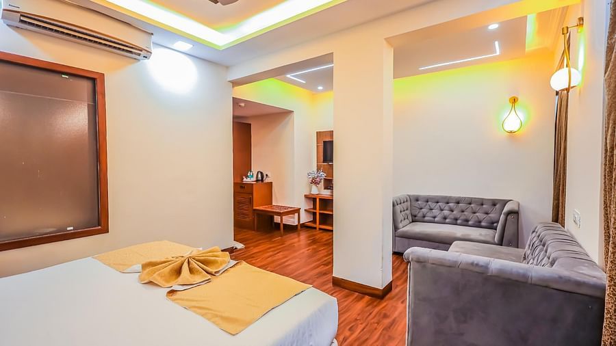 Executive room with seating area and sofa at Vagator Downtown, Goa 