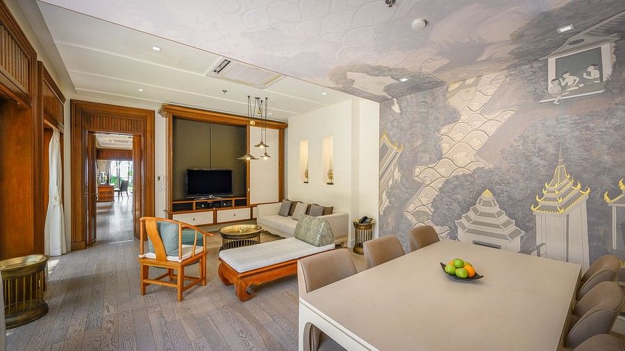 image of the living room featuring a dining area overlooking a television - one bedroom private pool beachfront villa