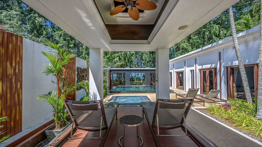image of a two chairs in a shed facing the swimming pool - one bedroom private pool beachfront villa