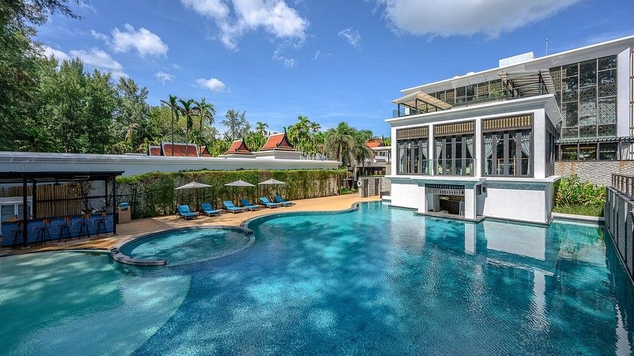 a panoramic image of the swimming pool with several sun loungers at the pool side - Maikhao Dream Villa Resort & Spa, Phuket