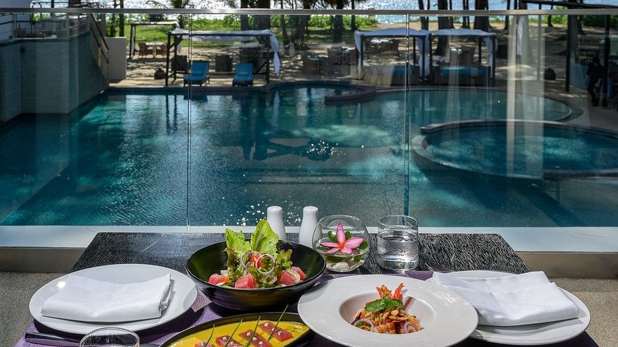 image of exotic food served with white porcelain plates served at the poolside - Maikhao Dream Villa Resort & Spa, Phuket