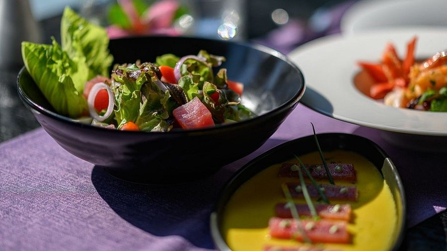 a close up image of the food served with exotic leafy vegetables and fish served in a gravy - Maikhao Dream Villa Resort & Spa, Phuket