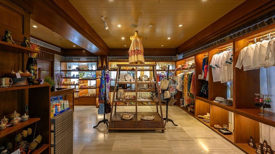 image of the souvenir shop featuring a rack in the middle with gift articles - Maikhao Dream Villa Resort & Spa, Phuket