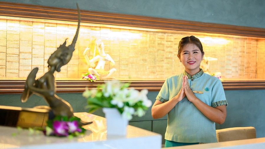 image of a staff member welcoming the guests to the Maikhao Dream Spa in Phuket