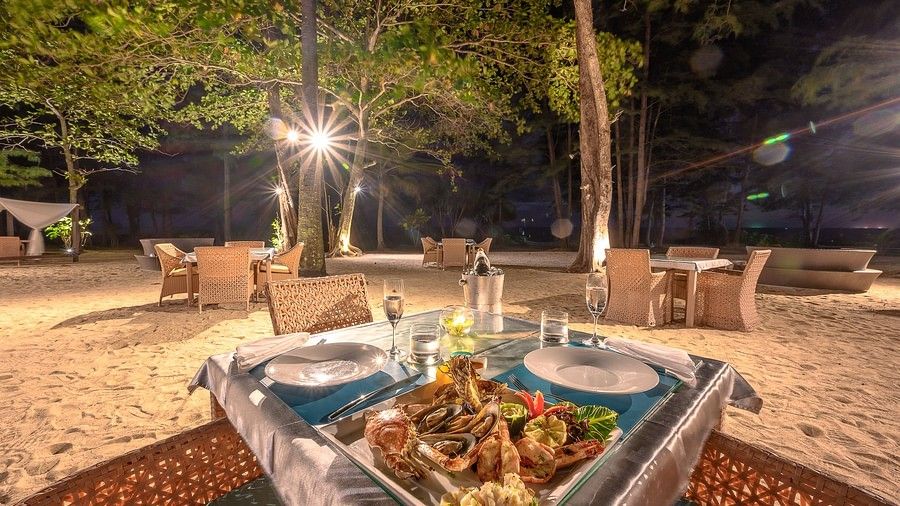 image of a dining table with a assorted seafood platter served at night time - Maikhao Dream Villa Resort & Spa, Phuket