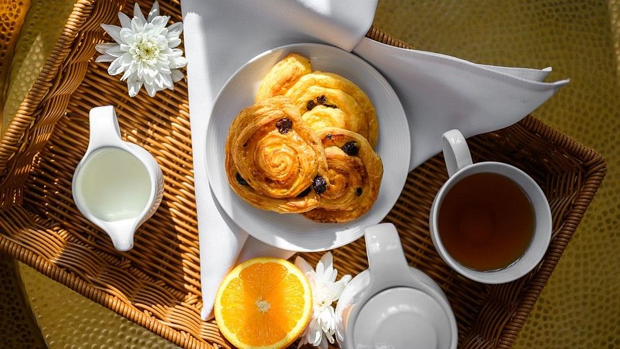 top view image of the breakfast featuring pancakes and a slice of orange - Maikhao Dream Villa Resort & Spa, Phuket