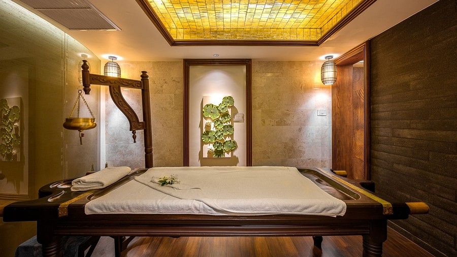 image of maikhao dream spa in phuket featuring a wooden bed in the middle of the room