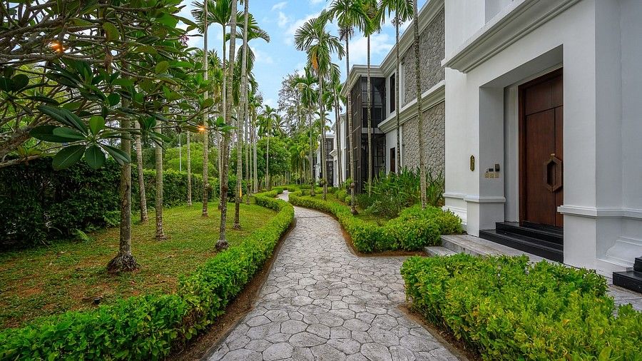 image of a pathway connecting individual villas with green bushes lining it - Maikhao Dream Villa Resort & Spa, Phuket