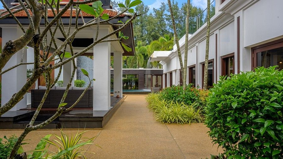 exterior image of the white coloured villas with brown pavements leading to individual stays - three bedroom private pool villa