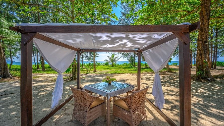 image of a dining table placed under a shed overlooking the beautiful sea and the tropical greenery - Maikhao Dream Villa Resort & Spa, Phuket
