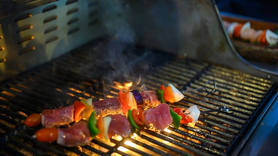 image featuring two skewers with vegetables and meat chunks placed on a grill at maikhao dream villa resort and spa, phuket