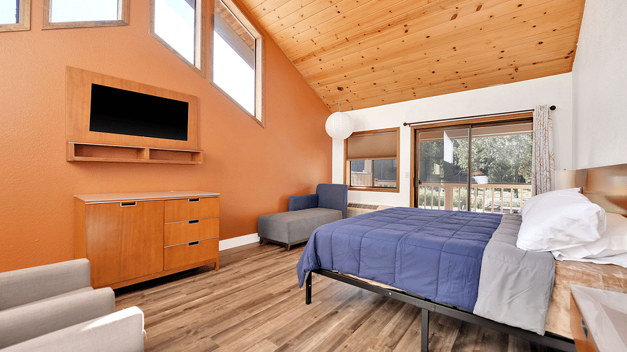 A view of a room at Amador Hotel with a double bed and a television.