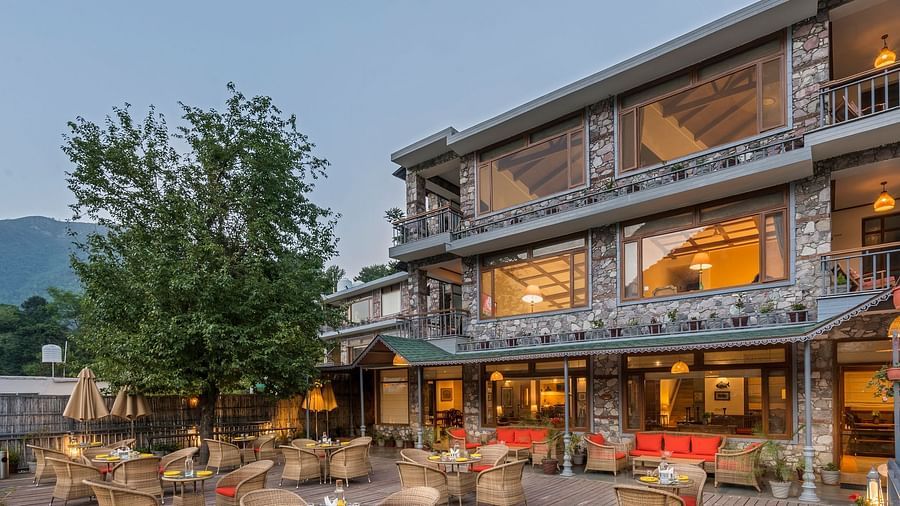 Outdoor restaurant at Fishermen's Lodge, Bhimtal, featuring a beautiful view, creating a perfect setting for dining in nature.