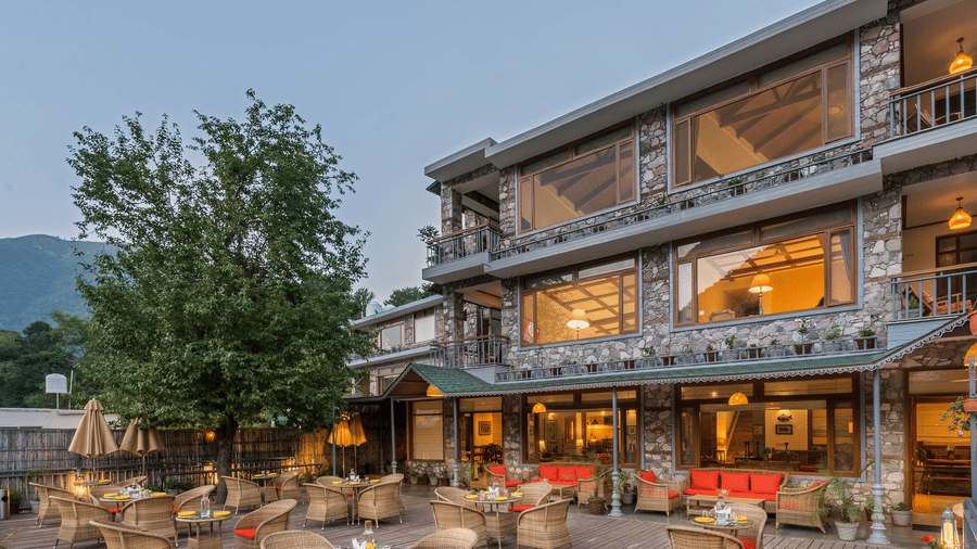 Outdoor restaurant at Fishermen's Lodge, Bhimtal, featuring a beautiful view, creating a perfect setting for dining in nature.