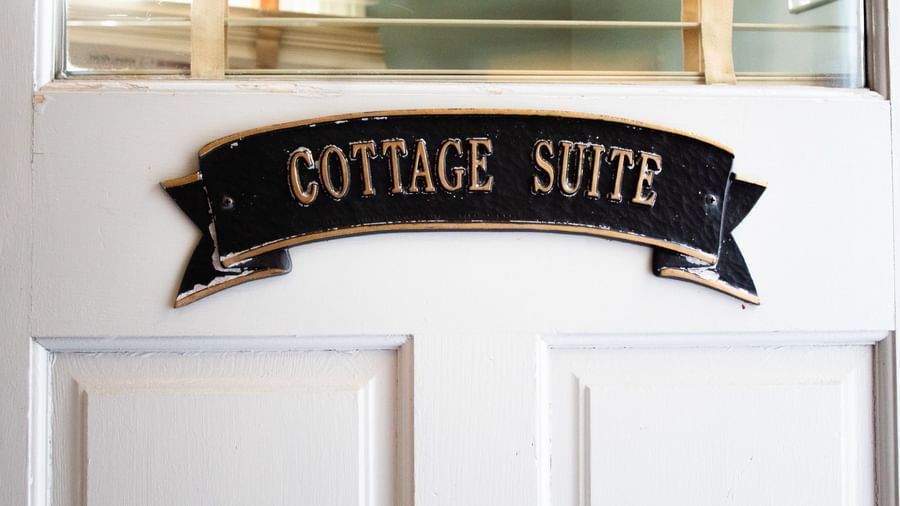 Cottage Suite door sign at Hartstone Inn on white door with glass panels above at Hartstone Inn.