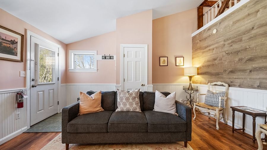 A room with a sitting area, designed cushions, and cozy lighting at Hartstone Inn