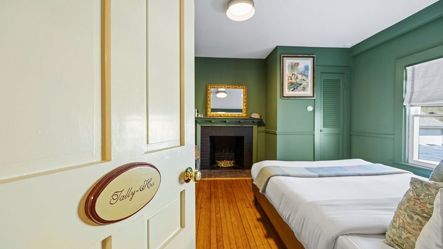 A room entry labelled 'Tally-Hoo' with view into bedroom featuring green walls and bed at Hartstone Inn.