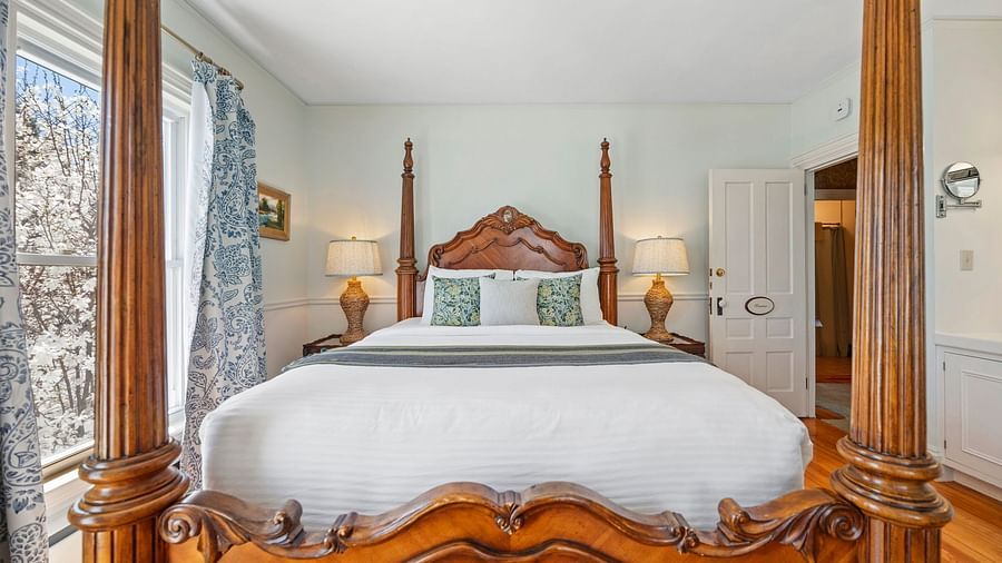 Room with ornate four-poster bed and classic decor at Hartstone Inn.
