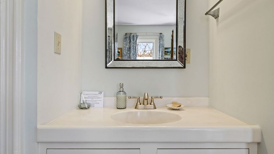 Bathroom vanity with mirror and toiletries at Hartstone Inn