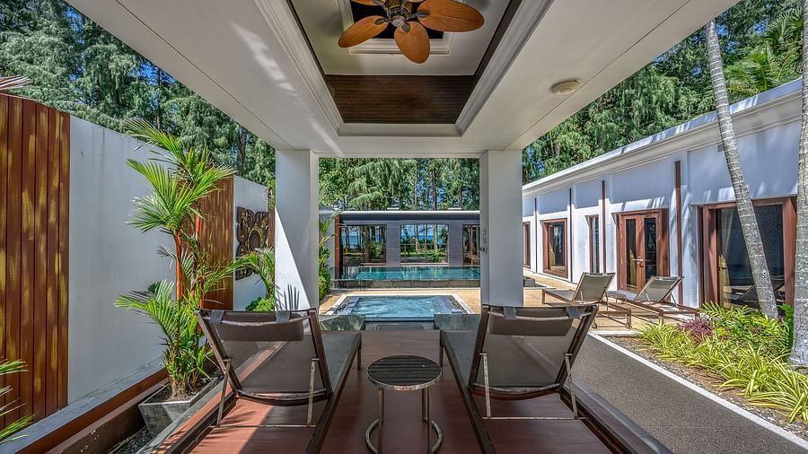 image of a two chairs in a shed facing the swimming pool - one bedroom private pool beachfront villa