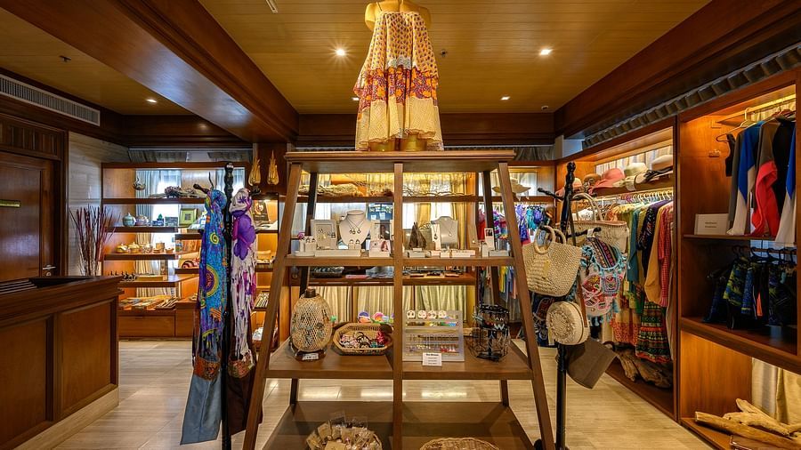 close up of a rack in a souvenir shop with clothes on display over it - Maikhao Dream Villa Resort & Spa, Phuket