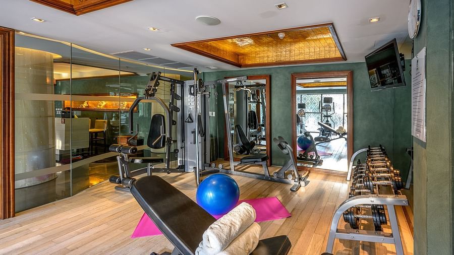 corner view of the fitness centre with a pink yoga mat in the centre of the room - Maikhao Dream Villa Resort & Spa, Phuket