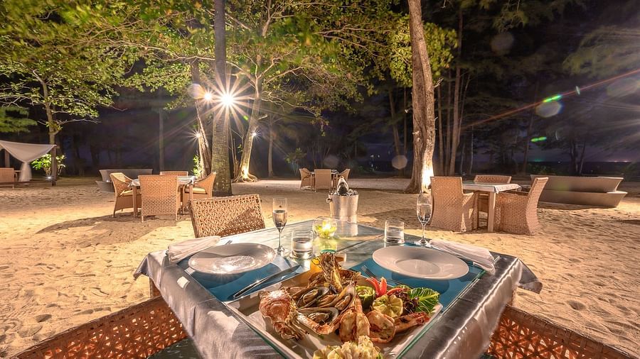 A dining table with a assorted seafood platter served at night time - Maikhao Dream Villa Resort & Spa, Phuket