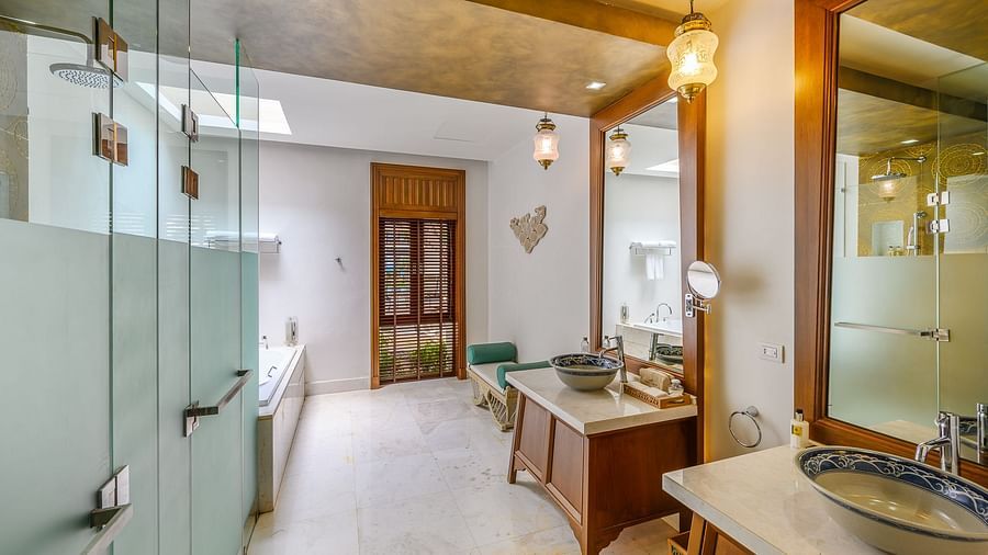 A spacious bathroom with two wash basins and shower cubicles - three bedroom private pool villa