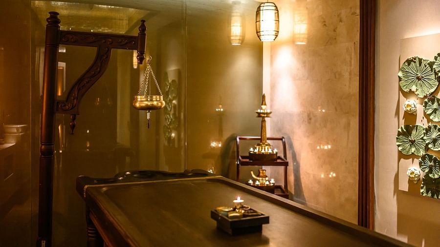 image of a wooden bed in the middle of the room with dim warm lighting at maikhao dream spa