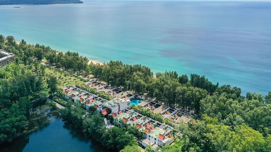 aerial view image of maikhao dream villa resort and spa with vast blue ocean in the background