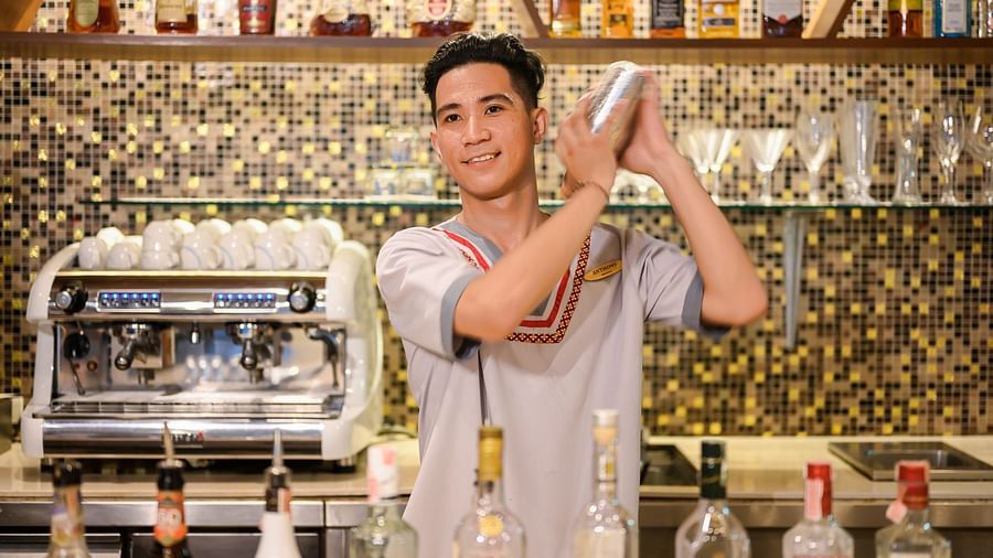 A professional bartender making cocktails behind the counter - Maikhao Dream Villa Resort & Spa, Phuket
