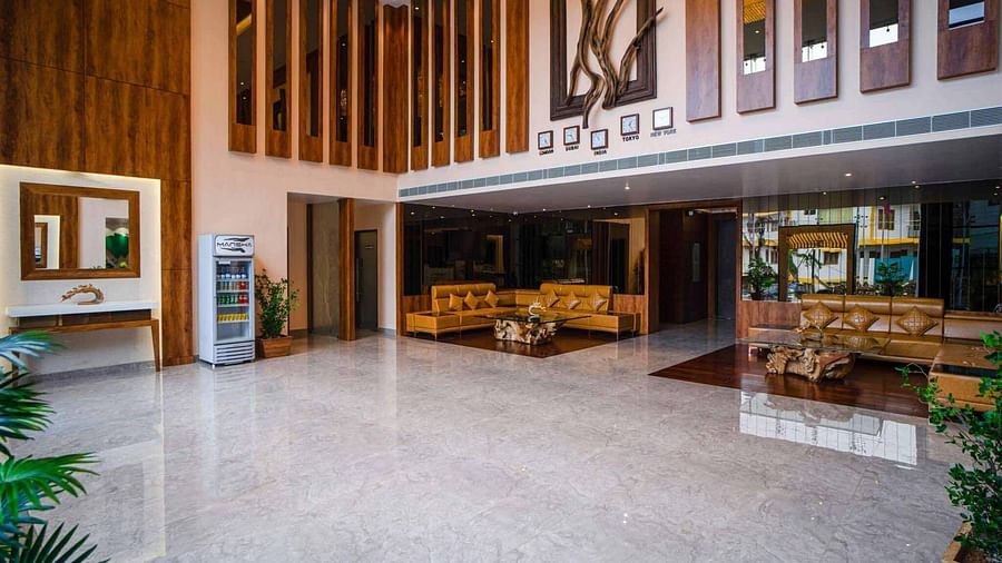 The spacious and elegantly designed lobby of Mansha Palace features warm wooden accents, comfortable seating, and a welcoming atmosphere.