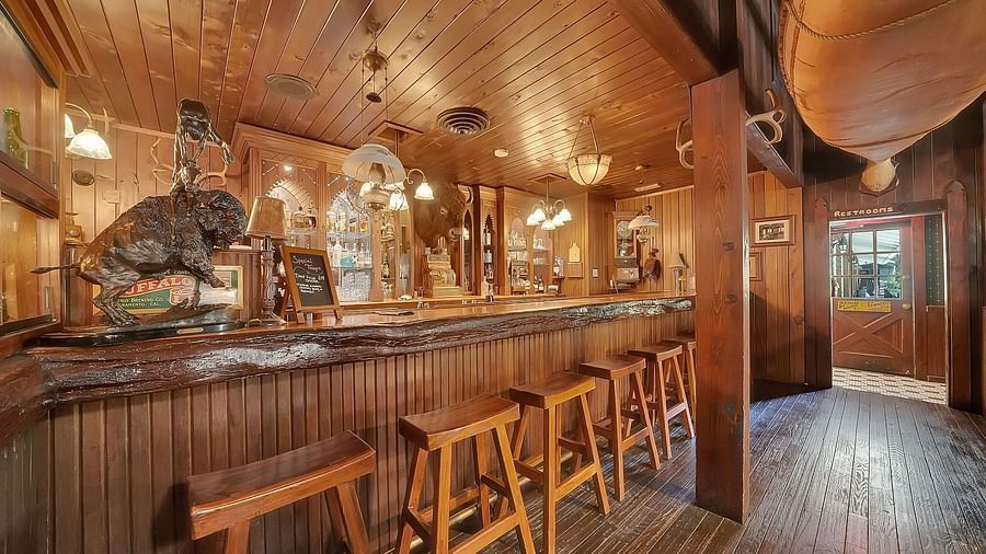 Bar counter seating area in a restaurant at Narrow Gauge Inn with a wooden theme.
