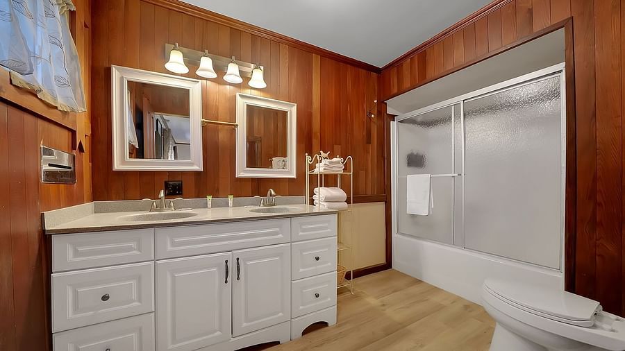A closet with a well-lit vanity and a large closet - Narrow Gauge Inn - A Serenite Hotel Near Fish Camp.