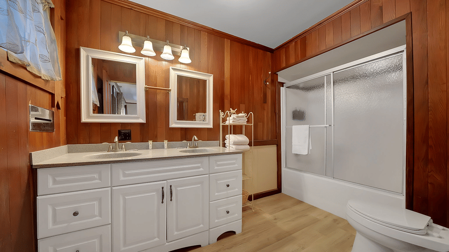 A closet with a well-lit vanity and a large closet - Narrow Gauge Inn - A Serenite Hotel Near Fish Camp.